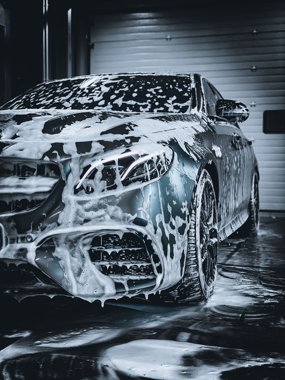 car being washed in an automatic car wash machine.